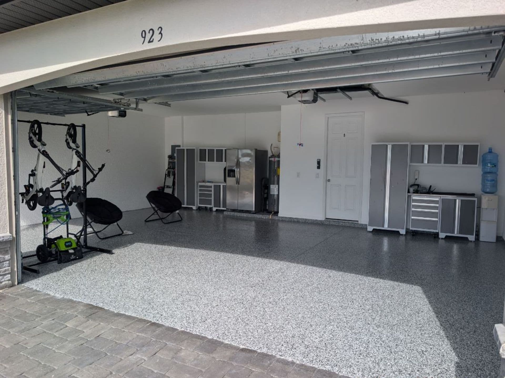 A garage with a reflective gray flake floor coating that is perfectly maintained