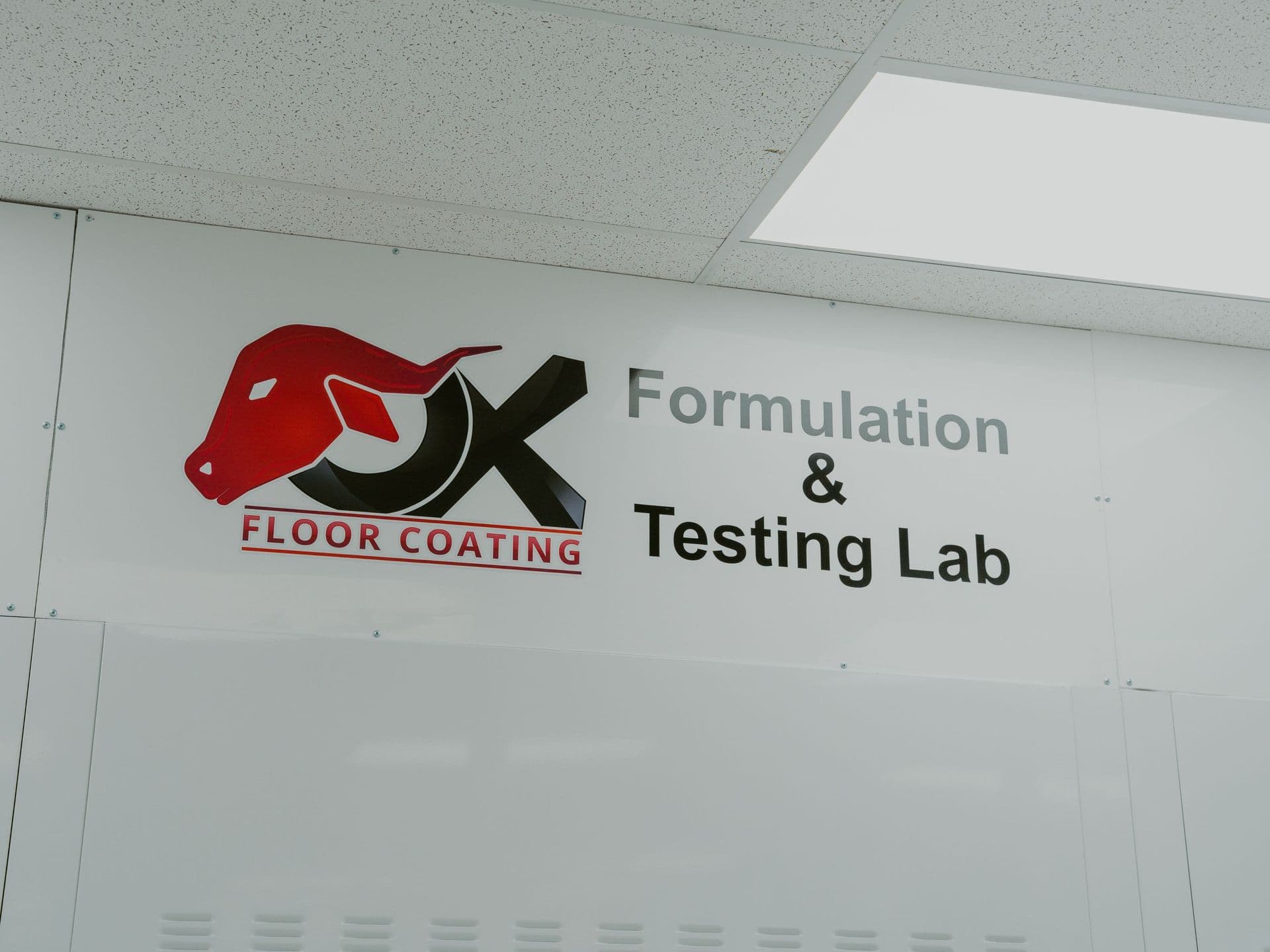 OX Floor Coating Formulation & Testing Lab signage highlighting the science behind 1-day garage floor coatings