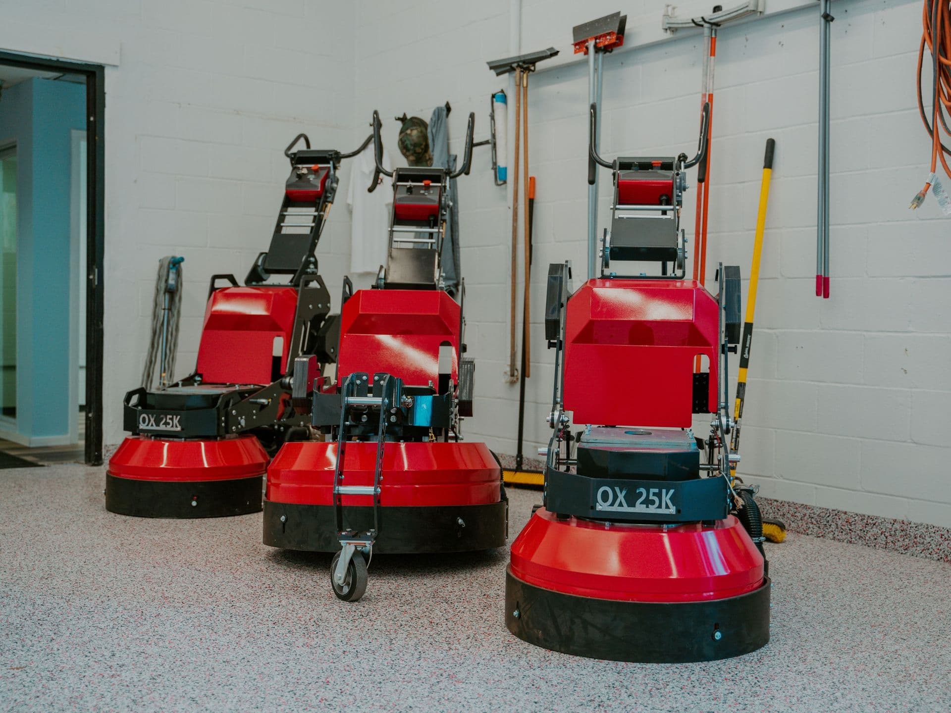 Professional concrete floor preparation equipment and red floor grinders used by a professional coating contractor