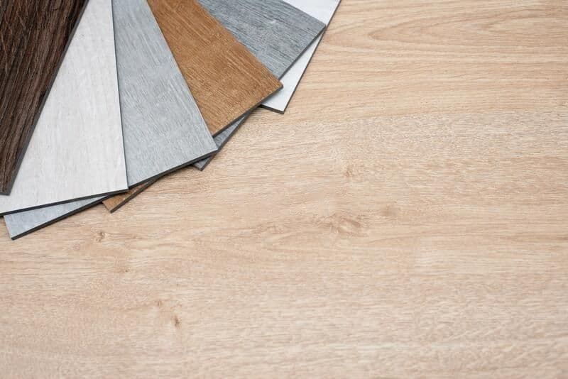 sample-catalog-luxury-vinyl-floor-tiles-new-interior-design-house-light-wooden-background-copy-space